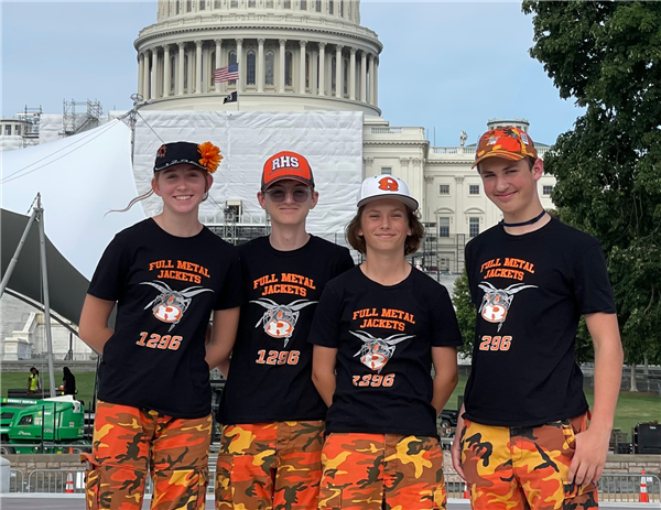  Four robotics team students stand in front of our nation's capitol.